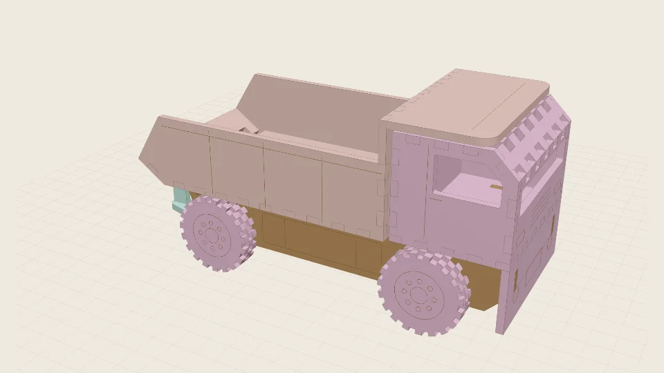 A laser-cut dump truck with a rock body and a cab over the front wheels