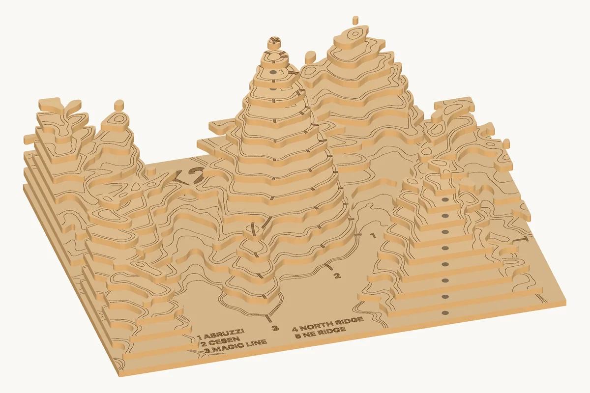 The K2 map pulled apart: the base sheet at the bottom, then twelve layers, each with the engraved outline of the one that goes on it