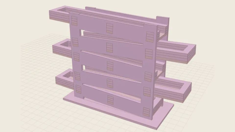 A laser-cut marble run: a tower of tilted trays held between two slotted side plates